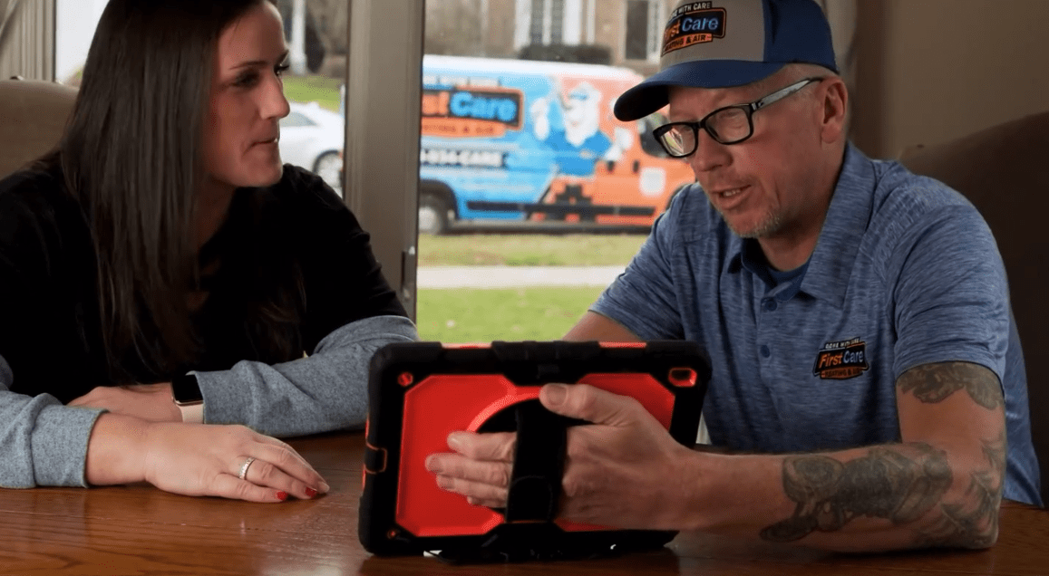 A First Care technician demonstrating his findings to a homeowner in St. Charles