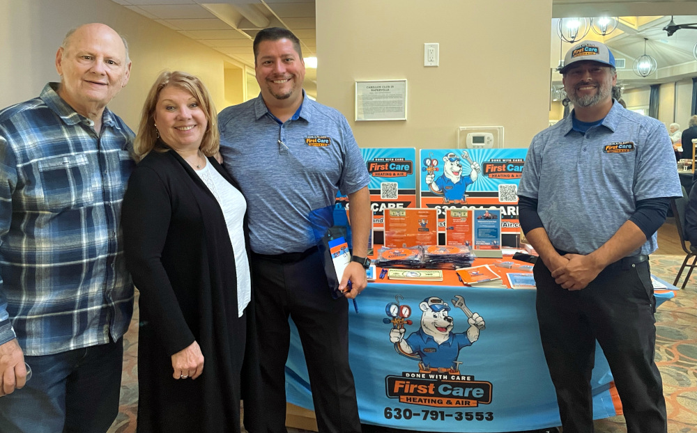 Smiling First Care founders at an event booth in Aurora
