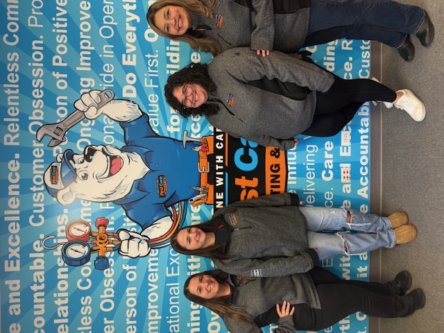 First Care team members standing in front of a wall of their values