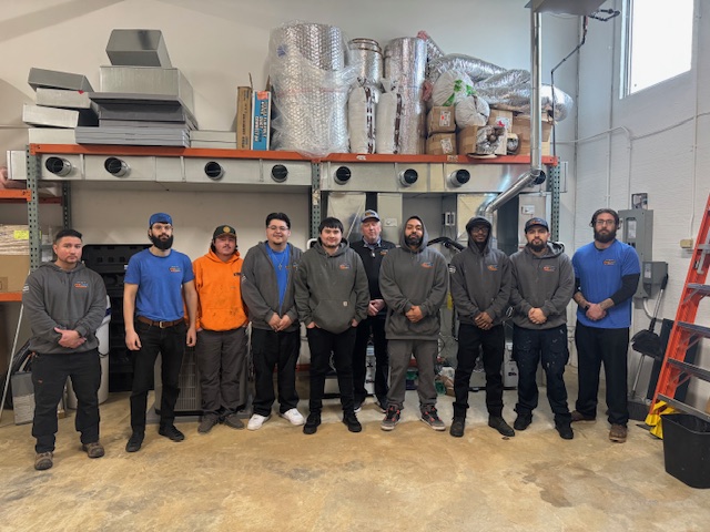 First Care team standing in front of shelf in warehouse
