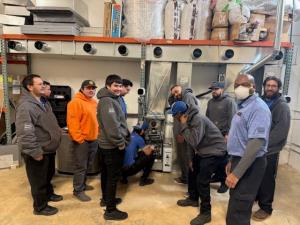 First Care Heating and Air LLC crew reviewing blueprints on a job site.