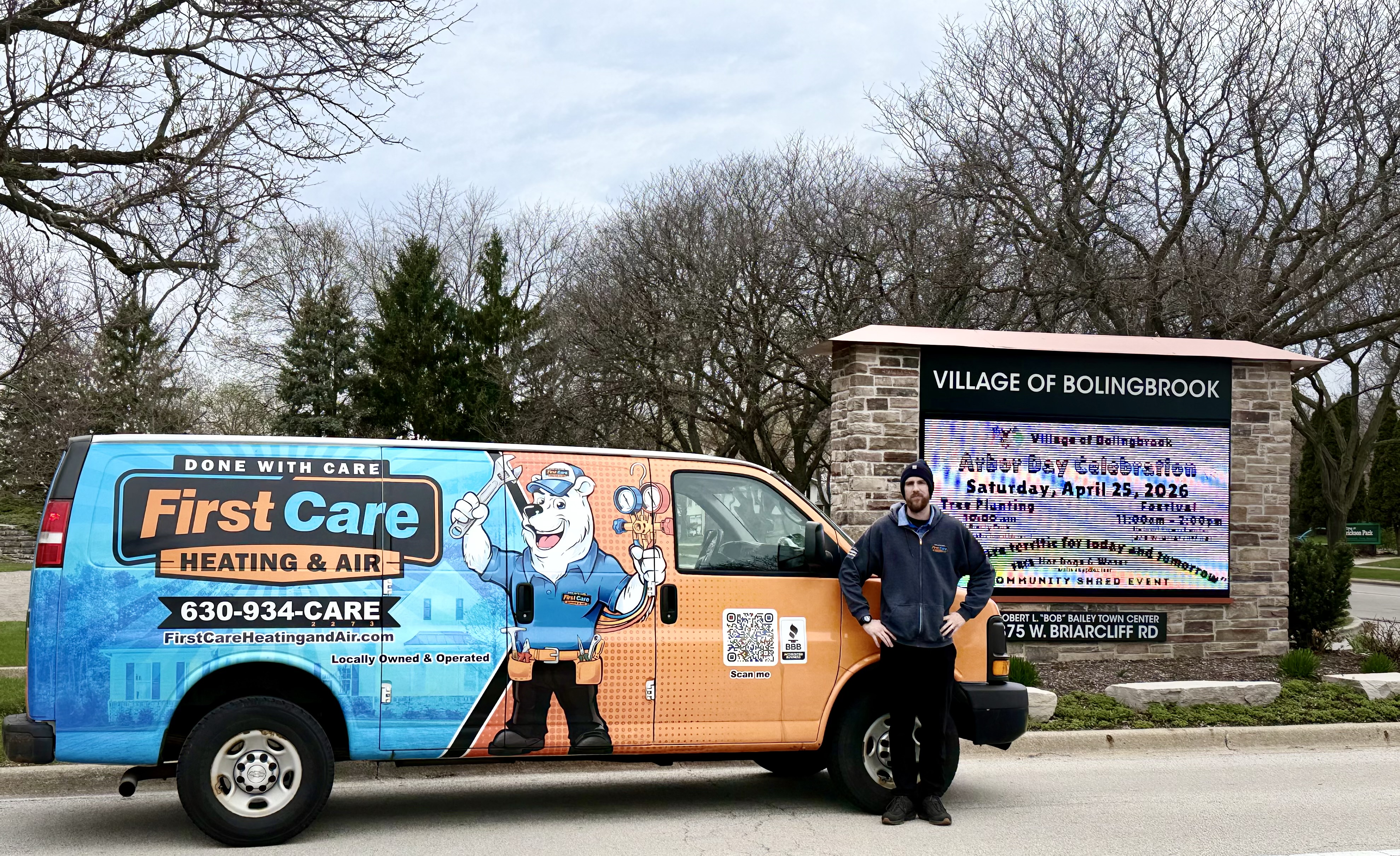 One of our technicians and vans in front of a Bolingbrook sign - get HVAC Service from First Care Heating and Air LLC today