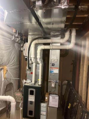 Technician testing a new smart thermostat's Wi-Fi connection.